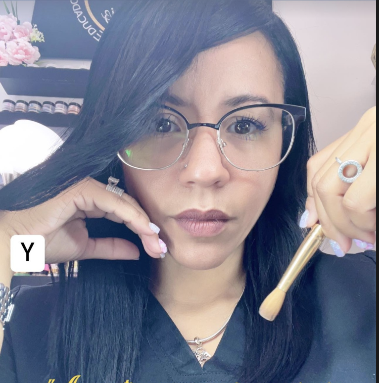 Experienced nail technician carefully crafting unique, detailed nail art designs in a professional salon environment.